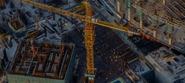 Aerial view of giant yellow crane working over a construction site